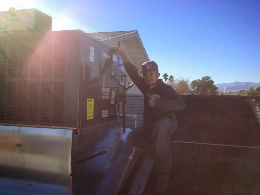 HVAC technician performing Air Duct Cleaning on a rooftop unit in Timberlane